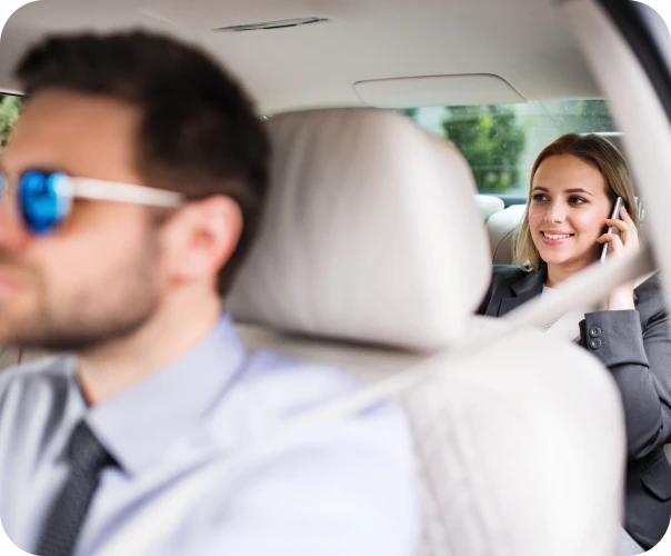 Chauffeur driving a busy woman